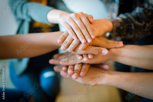 Teamwork putting their hands together,join hands partnership and teamwork concept.