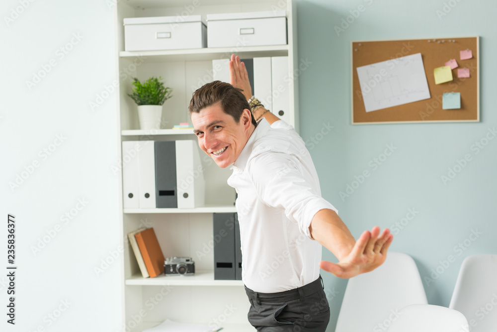 Handsome businessman having fun in the office Handsome businessman having fun in the office