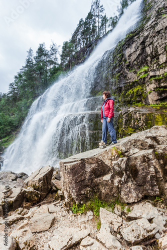 Tourist woman at waterfall Svandalsfossen, Norway