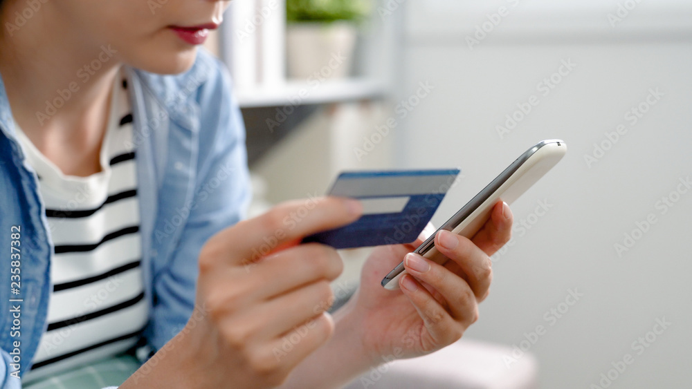lady holding credit card doing internet payment lady holding credit card doing internet payment