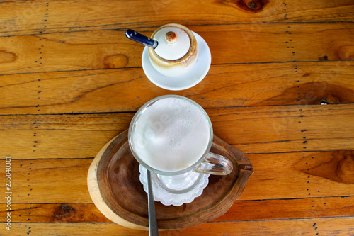 Cappuccino hot coffee on wooden table in coffeeshop and restaurant
