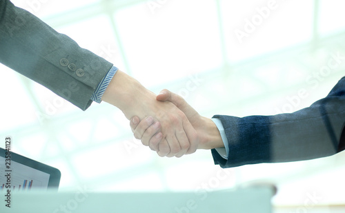 because of glass.handshake of business partners.bottom view