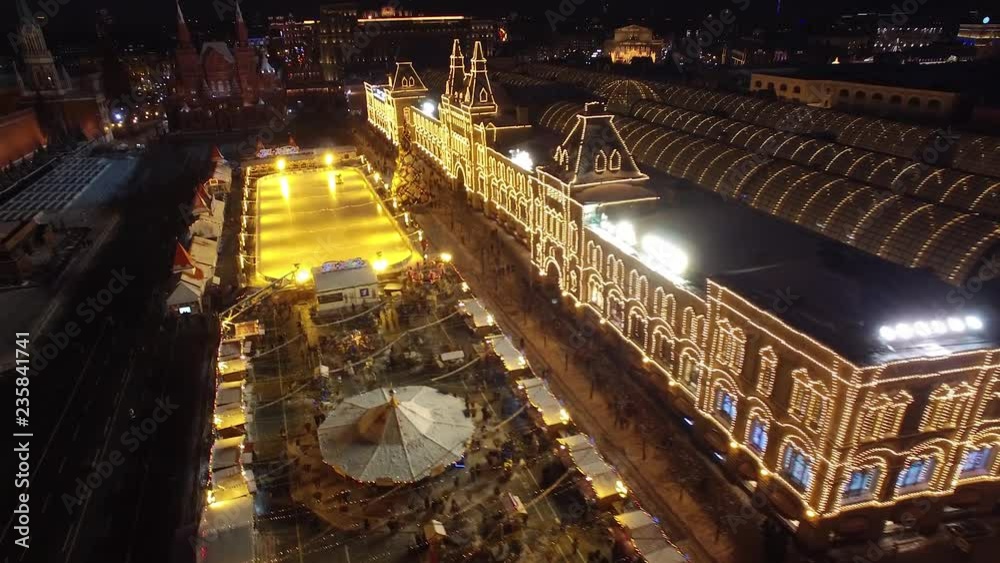Night illumination above Red Square winter holydays. Snow winter Moscow kremlin wall. Bright lights marker happy people walk. Scenery Festive Decoration. Unique drone 4k footage Night illumination above Red Square winter holydays. Snow winter Moscow kremlin wall. Bright lights marker happy people walk. Scenery Festive Decoration. Unique drone 4k footage