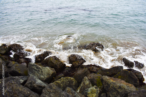 Splendorous waves of water crashing on rocks in the beach © Rob Avila