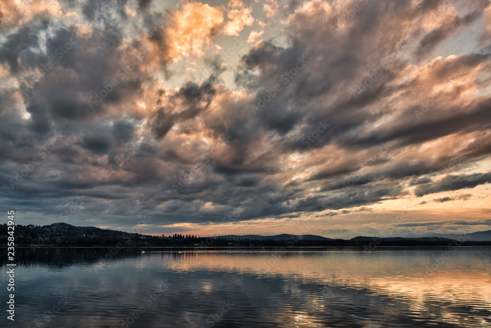 Clouds at the sunset over the lake