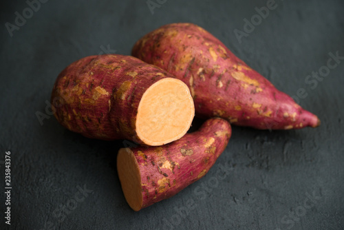organic orange sweet potato on dark background.