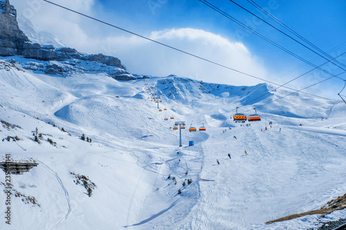Winter landscape ski chair lift and skiers in Switzerland photo