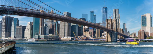 Panoramic view of Brooklyn bridge over Manhatten skyscrapers in New York.