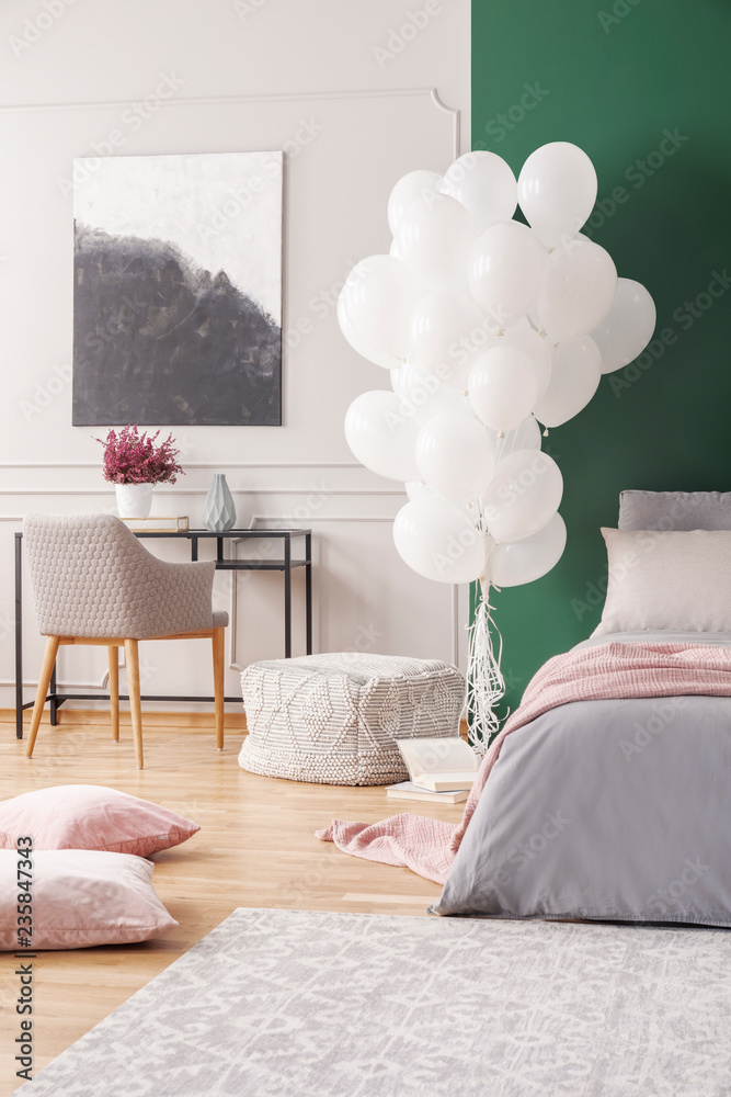Balloons in bedroom interior with pillows on a floor, bed and dark ...