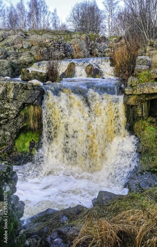 Fototapeta Naklejka Na Ścianę i Meble -  Small waterfall in ruins of old sawmill