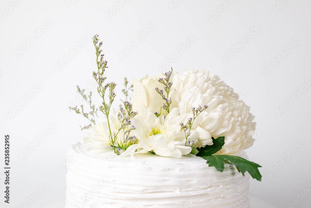 White flower on homemade cake.