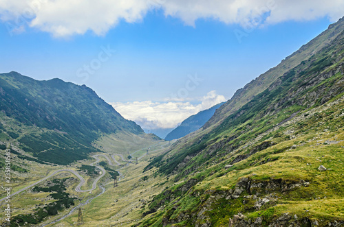 The Transfagarasan road in Fagaras mountains, Carpathians with green grass and rocks, peaks in the clouds © Negoi Cristian