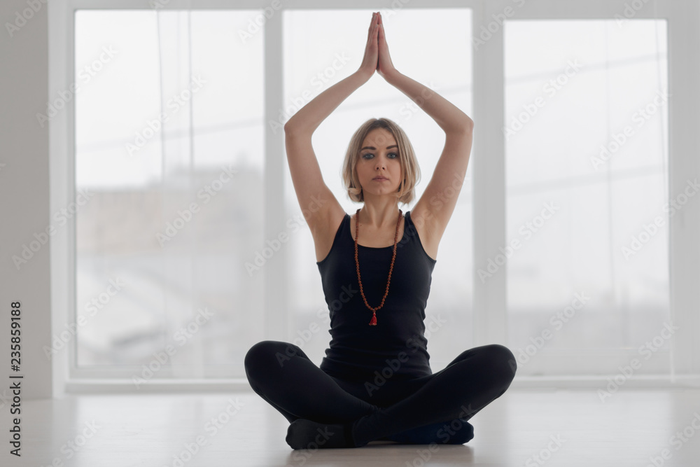Woman practicing yoga in the gym Woman practicing yoga in the gym