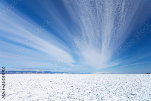 Lake Baikal in winter. Beautiful stratus clouds above the field of snowbound ice hummocks on Small Sea (Maloe More) Strait. Natural  background