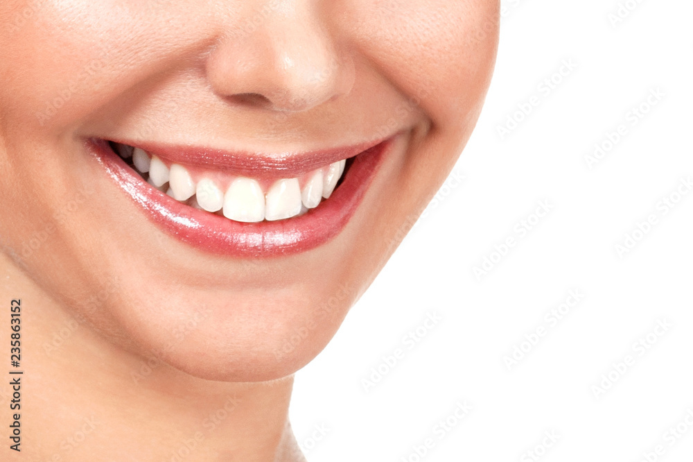 Closeup shot of beautiful female smile, isolated on white background Closeup shot of beautiful female smile, isolated on white background