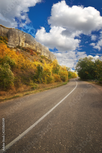 Asphalt Road path walkway near autumn mountain. © silentgos
