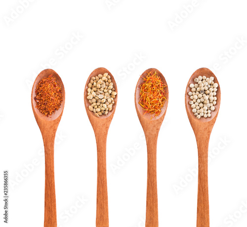 Spices mix on wooden spoons isolated on a white background. Top view