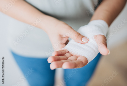 Fotobehang Woman with gauze bandage wrapped around her hand
