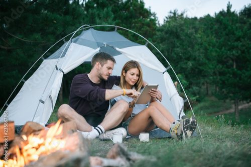Young man and woman looking for direction on digital tablet 