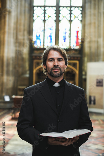 Christian priest standing by the altar