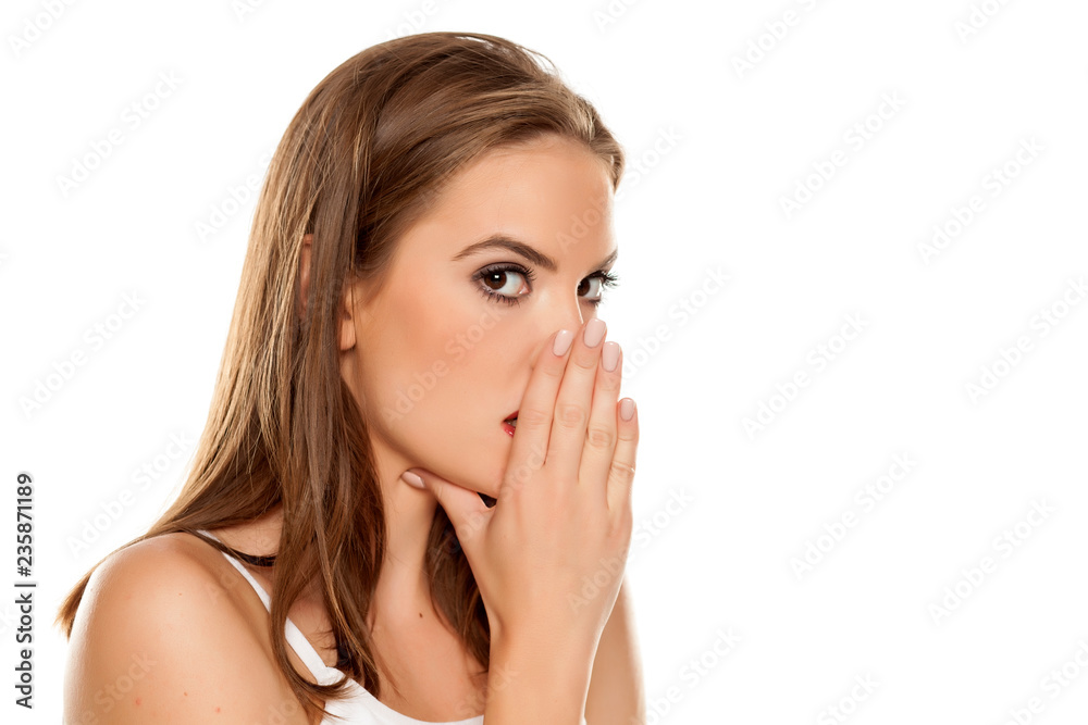 Beautiful girl whispering on white background Beautiful girl whispering on white background