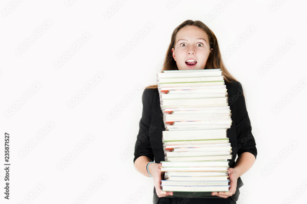Beautiful girl holding a large number of books on an isolated white background Beautiful girl holding a large number of books on an isolated white background