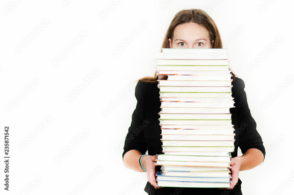 Beautiful girl holding a large number of books on an isolated white background Beautiful girl holding a large number of books on an isolated white background