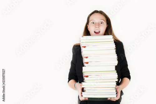 Beautiful girl holding a large number of books on an isolated white background