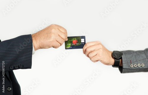 hands of men transferring a credit card or business card on an isolated background