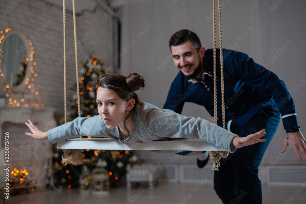 Father and daughter have fun on Christmas eve.