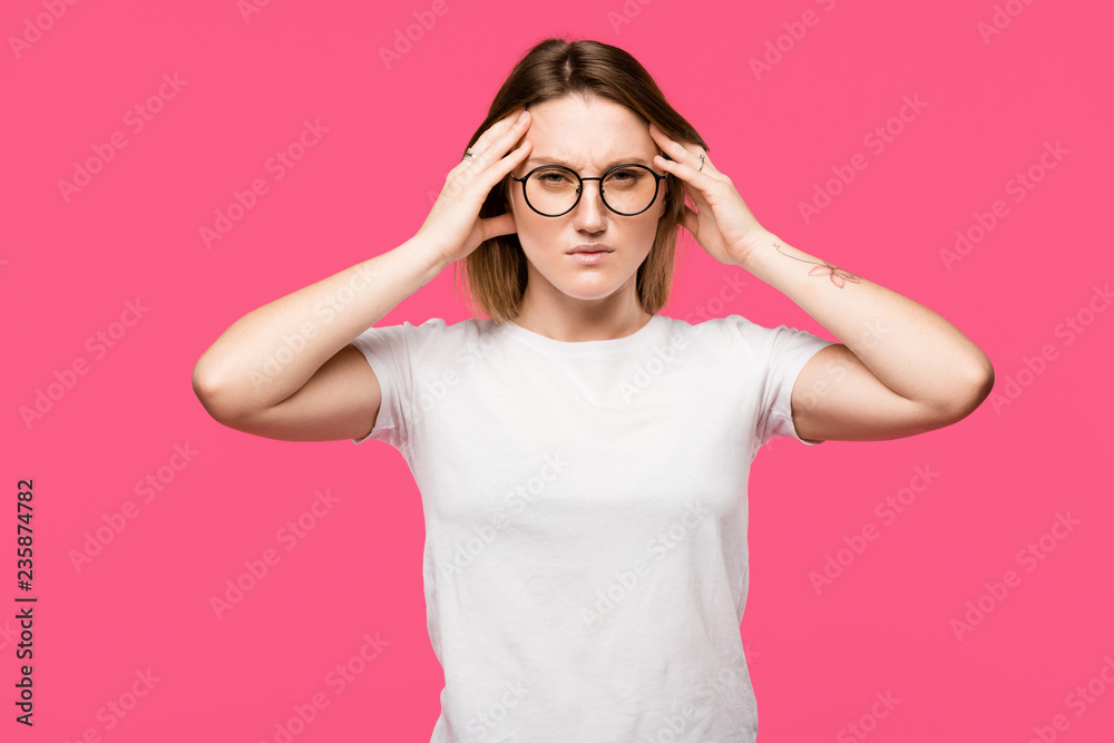 irritated woman in eyeglasses having headache isolated on pink irritated woman in eyeglasses having headache isolated on pink