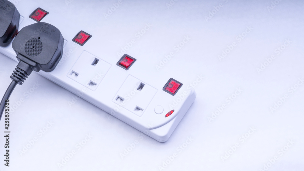 Extension cord and power plug on white background with selective focus and crop fragment Extension cord and power plug on white background with selective focus and crop fragment