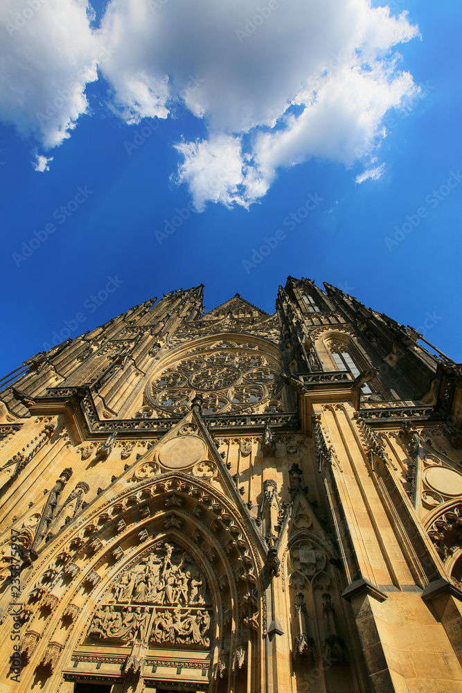 Prague, Czech Republic, view of the Gothic Catholic Cathedral of St. Vitus in Prague Castle and white clouds in the blue sky