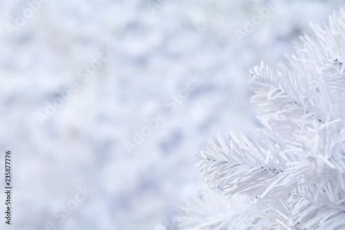 White Christmas tree background with blurred snow effect