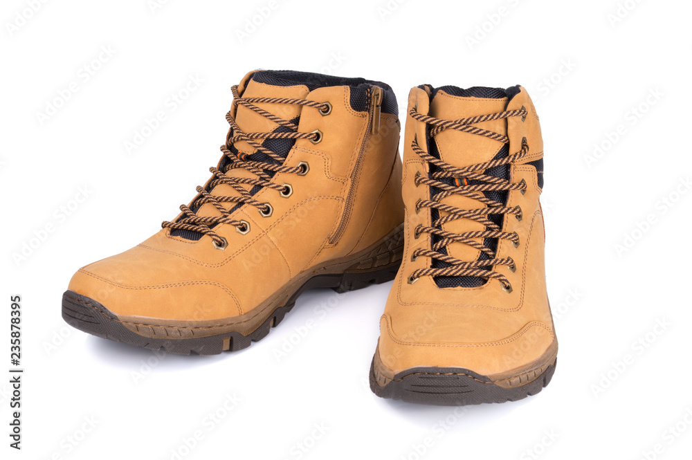 Two brown leather hiking boots or shoes isolated on white background. Two brown leather hiking boots or shoes isolated on white background.