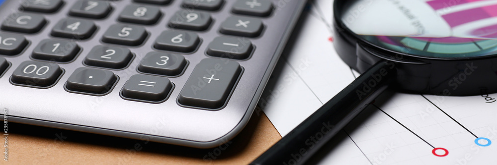 Silver calculator and financial statistics on clipboard Silver calculator and financial statistics on clipboard