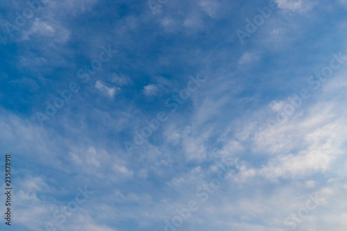 Blue sky with scattered clouds.