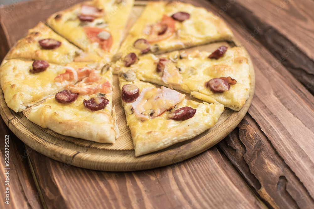 Pizza on a dark wooden background. Pizza on a dark wooden background.