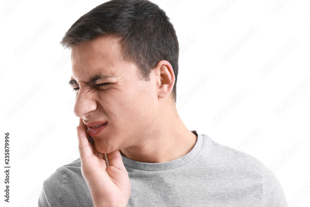 Obraz premium Young man suffering from toothache on white background