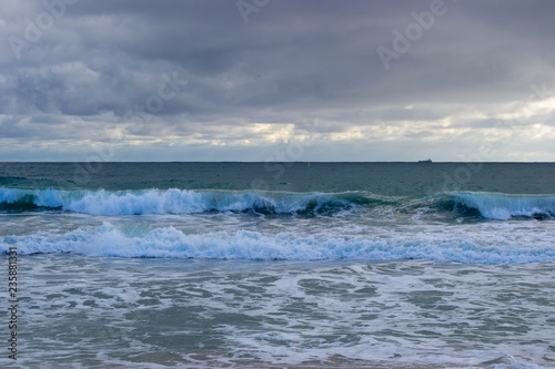 Landscape of a beach in north perth in a windy day full of waves water