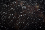Water droplets on black background rain macro