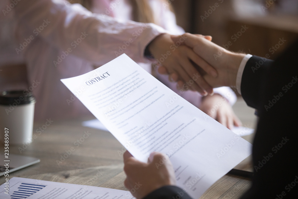 Business partners handshaking signing contract. Deal with good result, start of work with business partner or customer, agreement conclusion, client enters into a contract, human resource. Close up Business partners handshaking signing contract. Deal with good result, start of work with business partner or customer, agreement conclusion, client enters into a contract, human resource. Close up