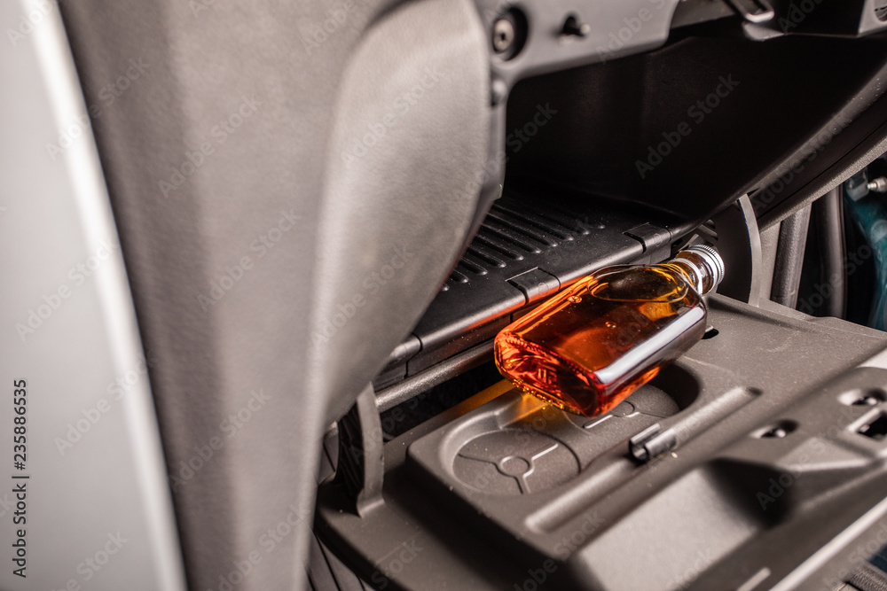 Drink and drive. Bottle of alcohol inside the car. Don't Drink for Drive Drink and drive. Bottle of alcohol inside the car. Don't Drink for Drive