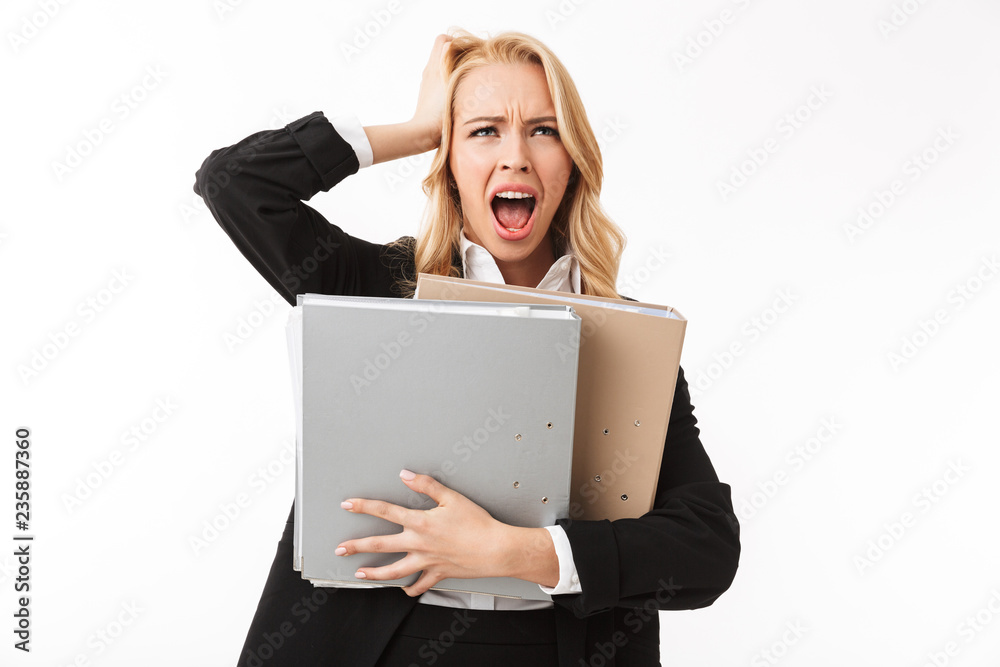 Photo of manager girl wearing office suit screaming while holding paper folders, isolated over white background in studio Photo of manager girl wearing office suit screaming while holding paper folders, isolated over white background in studio