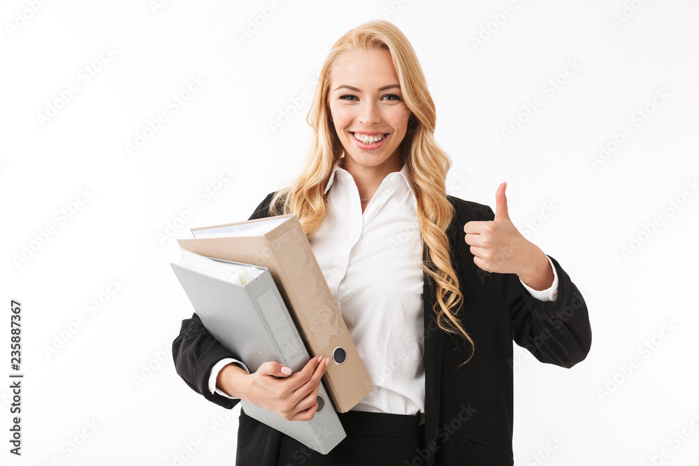 Photo of successful businesswoman wearing office suit holding paper folders in hands, isolated over white background in studio Photo of successful businesswoman wearing office suit holding paper folders in hands, isolated over white background in studio