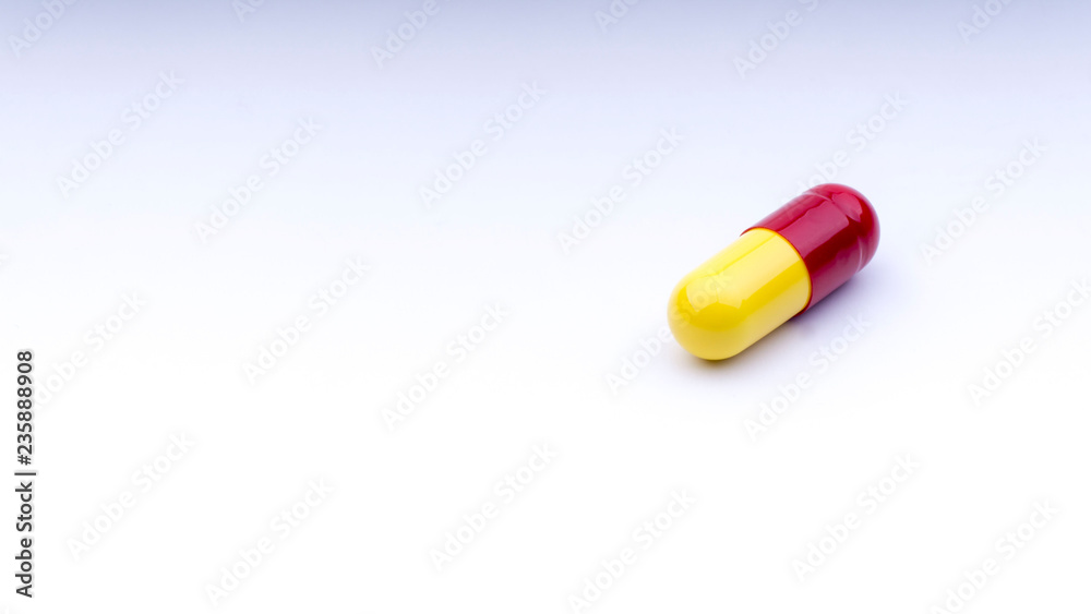 Medicine pills or capsules closeup on a white background with selective focus and crop fragment Medicine pills or capsules closeup on a white background with selective focus and crop fragment