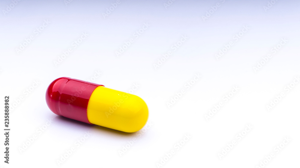 Medicine pills or capsules closeup on a white background with selective focus and crop fragment Medicine pills or capsules closeup on a white background with selective focus and crop fragment