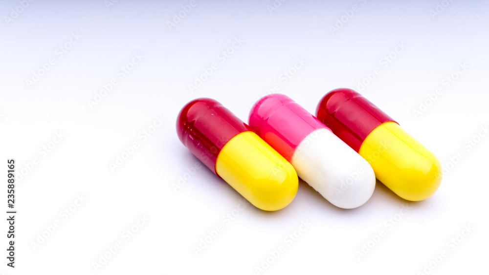 Medicine pills or capsules closeup on a white background with selective focus and crop fragment Medicine pills or capsules closeup on a white background with selective focus and crop fragment