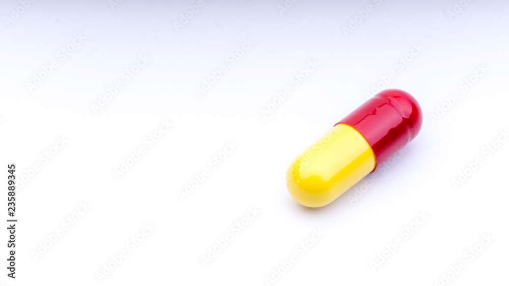 Medicine pills or capsules closeup on a white background with selective focus and crop fragment Medicine pills or capsules closeup on a white background with selective focus and crop fragment
