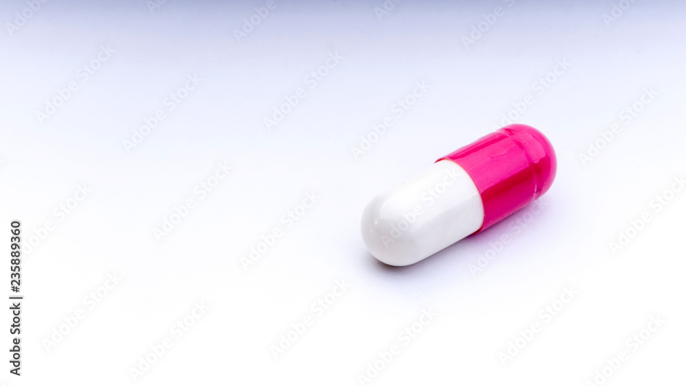 Medicine pills or capsules closeup on a white background with selective focus and crop fragment Medicine pills or capsules closeup on a white background with selective focus and crop fragment